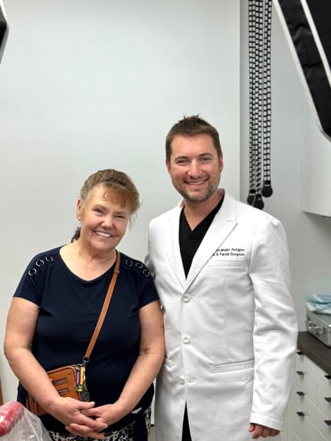 Dr. Alexander Antipov with a happy full-arch patient after treatment in Roseville, CA