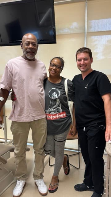 Dr. Alexander Antipov with grateful patients following oral surgery in Roseville, CA