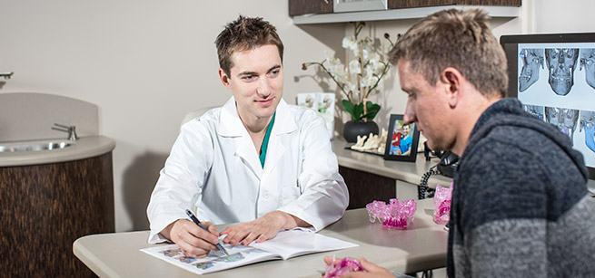 Dr Antipov with patient on consultation at Galleria Oral and Maxillofacial Surgery Center